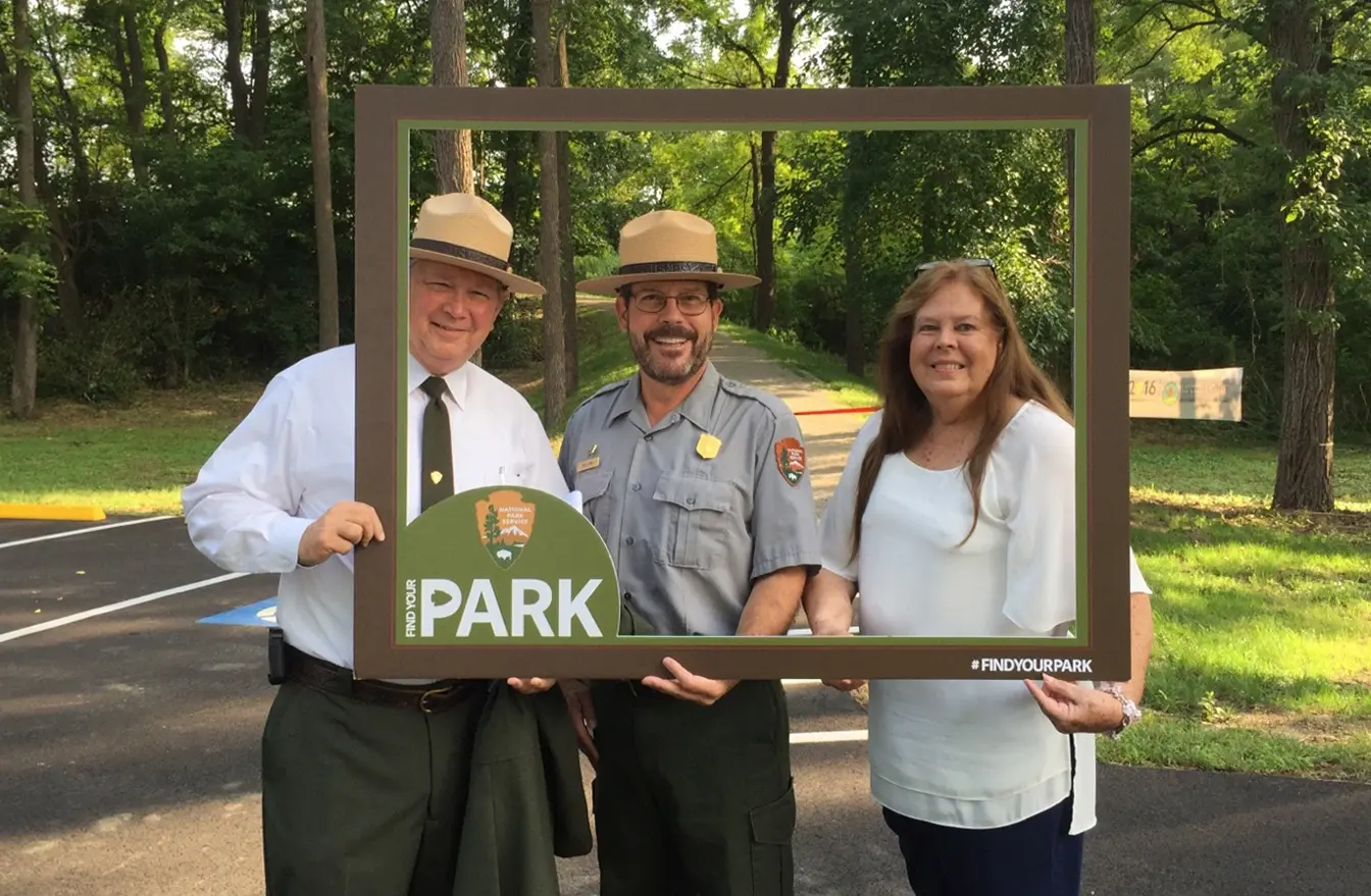 Find your park picture frame with 3 people smiling